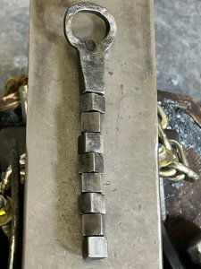 Forged cubic bottle opener