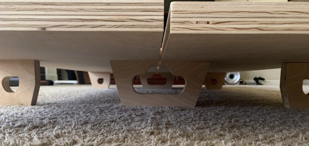 Feet of the custom plywood platform bed with interchangable panels
